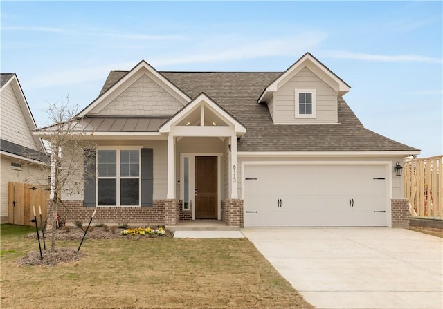 craftsman inspired home featuring brick siding, a garage, concrete driveway, and a standing seam roof