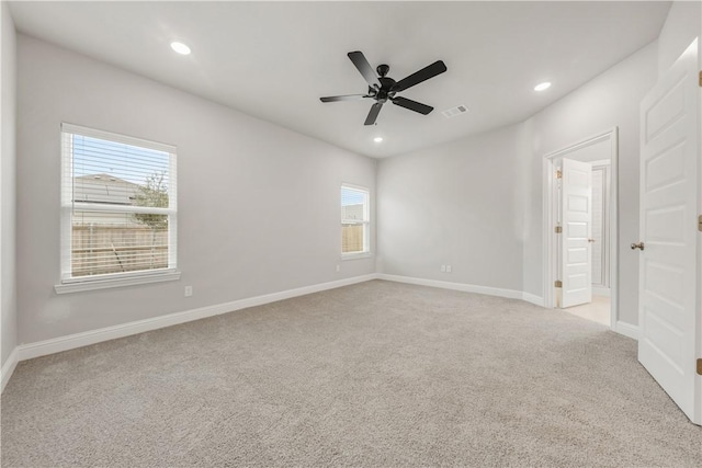 empty room with a ceiling fan, visible vents, baseboards, recessed lighting, and light carpet