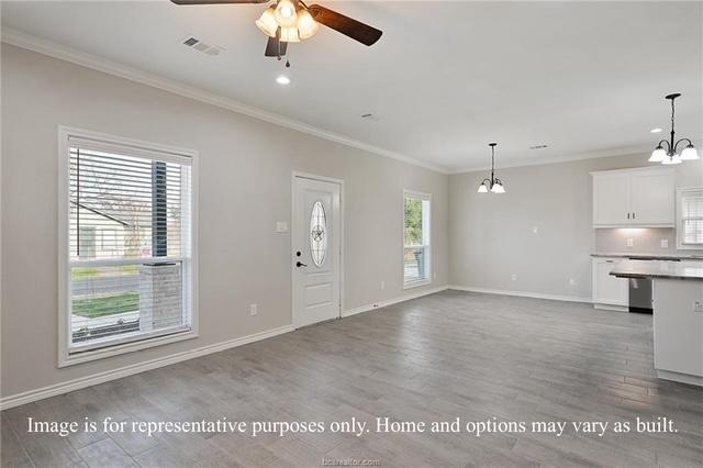 entrance foyer with baseboards, wood finished floors, crown molding, and ceiling fan with notable chandelier