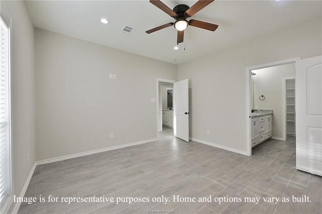 unfurnished bedroom featuring a spacious closet, visible vents, baseboards, light wood-style flooring, and recessed lighting