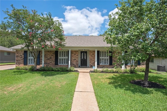 2909 River Oaks Cir, Bryan, TX 77802 - single story home featuring central AC, a front yard, brick siding, and a porch