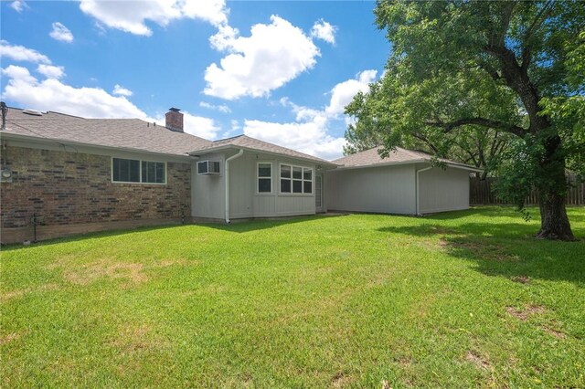 2909 River Oaks Cir, Bryan, TX 77802 - back of house with a chimney and a wall mounted AC