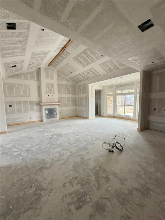 unfurnished living room with vaulted ceiling