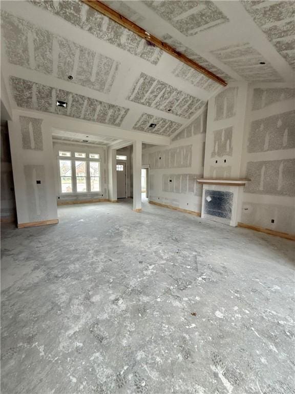 unfurnished living room with vaulted ceiling