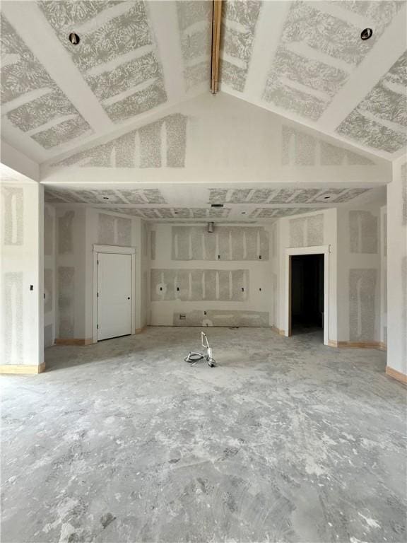 unfurnished living room with lofted ceiling