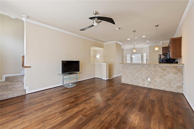 unfurnished living room with ceiling fan, ornamental molding, and dark hardwood / wood-style floors