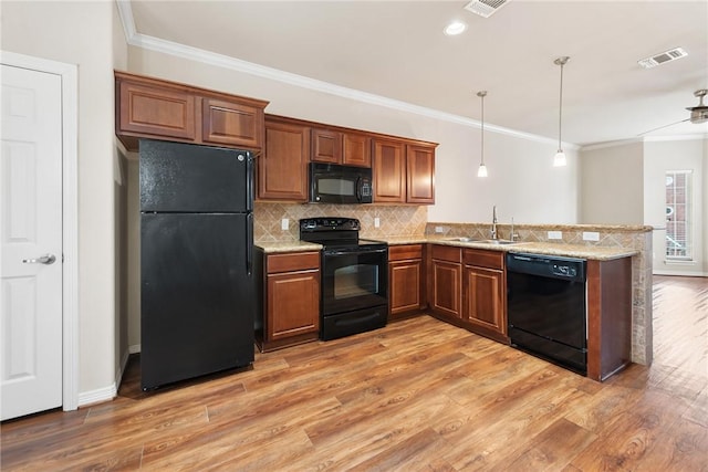 kitchen featuring black appliances, wood-type flooring, decorative backsplash, kitchen peninsula, and crown molding