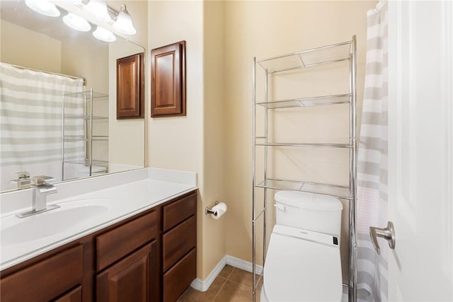 bathroom with tile patterned flooring, vanity, and toilet