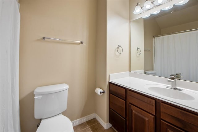 bathroom featuring tile patterned flooring, vanity, and toilet