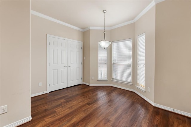 unfurnished room with dark wood-type flooring, ornamental molding, and a healthy amount of sunlight