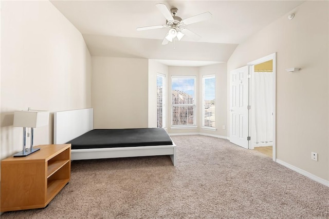 unfurnished bedroom featuring ceiling fan, lofted ceiling, and carpet