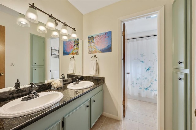 bathroom with toilet, tile patterned flooring, and vanity