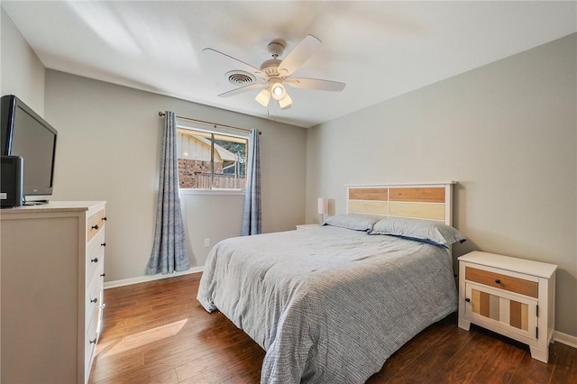 bedroom with dark wood-type flooring and ceiling fan