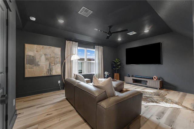 cinema featuring lofted ceiling, ceiling fan, and light wood-type flooring