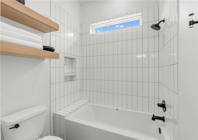 bathroom featuring tiled shower / bath and toilet