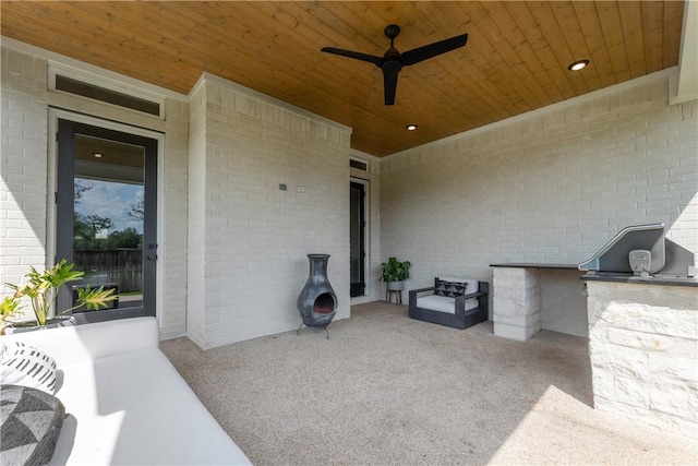 view of patio with area for grilling and ceiling fan