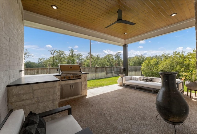 view of patio / terrace with ceiling fan, grilling area, and exterior kitchen