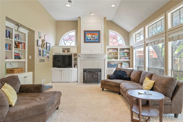 4719 Hunington Dr, Bryan, TX 77802 - carpeted living room featuring healthy amount of natural light, a large fireplace, and high vaulted ceiling