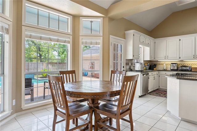 4719 Hunington Dr, Bryan, TX 77802 - dining room with light tile patterned flooring and vaulted ceiling