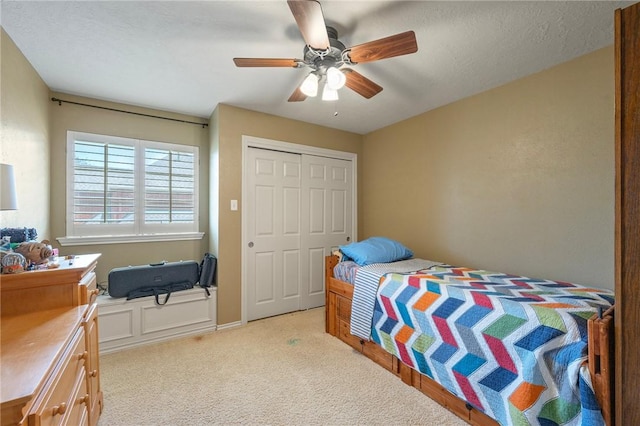 4719 Hunington Dr, Bryan, TX 77802 - bedroom with light carpet, a closet, and a ceiling fan