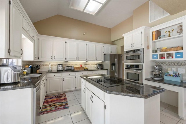 4719 Hunington Dr, Bryan, TX 77802 - kitchen with stainless steel appliances, light tile patterned floors, tasteful backsplash, a center island, and vaulted ceiling
