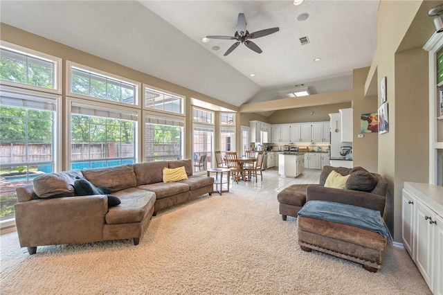 4719 Hunington Dr, Bryan, TX 77802 - living area featuring light colored carpet, healthy amount of natural light, a ceiling fan, and vaulted ceiling