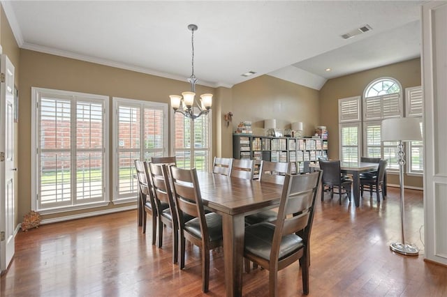 4719 Hunington Dr, Bryan, TX 77802 - dining space featuring wood finished floors, a chandelier, vaulted ceiling, and ornamental molding