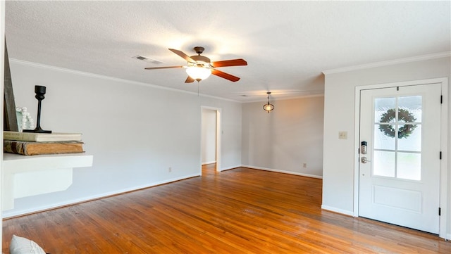 1002 Edgewood Dr, Bryan, TX 77802 - unfurnished living room with wood finished floors, a ceiling fan, baseboards, and crown molding