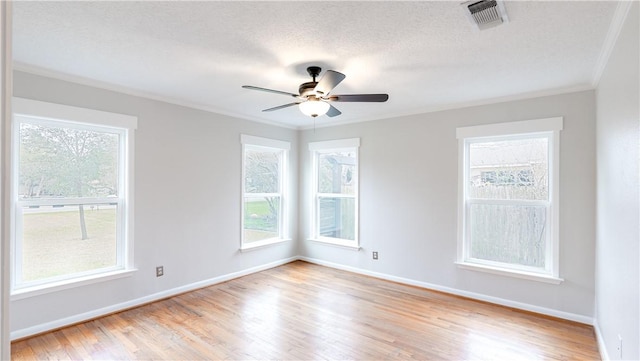 1002 Edgewood Dr, Bryan, TX 77802 - empty room featuring ornamental molding, light wood-style floors, plenty of natural light, baseboards, and ceiling fan
