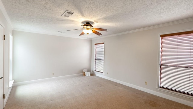 1002 Edgewood Dr, Bryan, TX 77802 - empty room featuring a ceiling fan, crown molding, light colored carpet, baseboards, and a textured ceiling