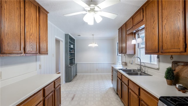 1002 Edgewood Dr, Bryan, TX 77802 - kitchen with a sink, ornamental molding, brown cabinetry, light flooring, and stainless steel dishwasher