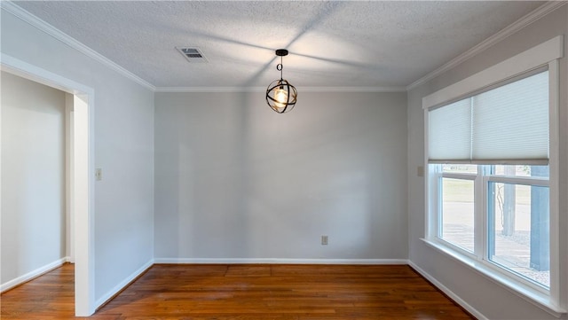 1002 Edgewood Dr, Bryan, TX 77802 - spare room with wood finished floors, a textured ceiling, crown molding, and baseboards
