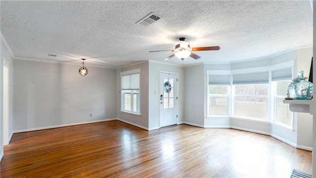 1002 Edgewood Dr, Bryan, TX 77802 - spare room featuring wood finished floors, a ceiling fan, crown molding, baseboards, and a textured ceiling