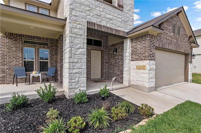 property entrance featuring covered porch and a garage