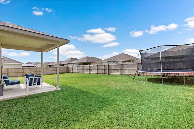 view of yard with a patio and a trampoline