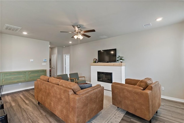 living room featuring hardwood / wood-style floors and ceiling fan