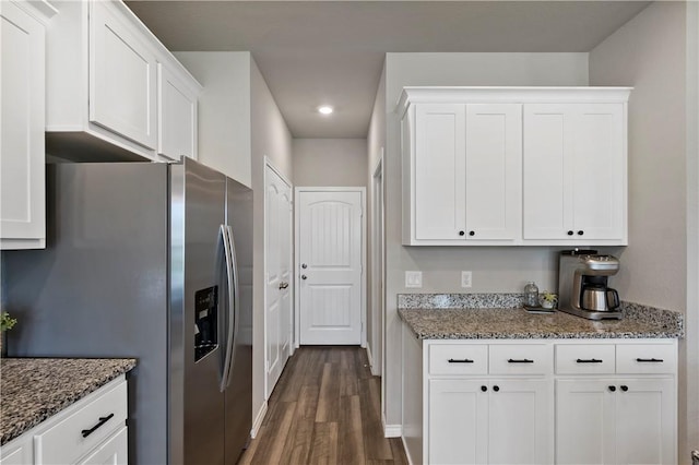 kitchen featuring dark stone countertops, white cabinets, dark hardwood / wood-style floors, and stainless steel refrigerator with ice dispenser