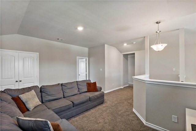 living room with dark colored carpet and vaulted ceiling