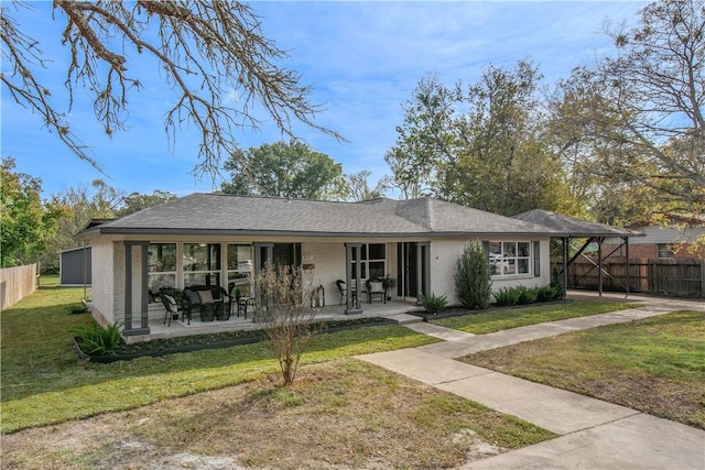 view of front of house with a patio and a front yard