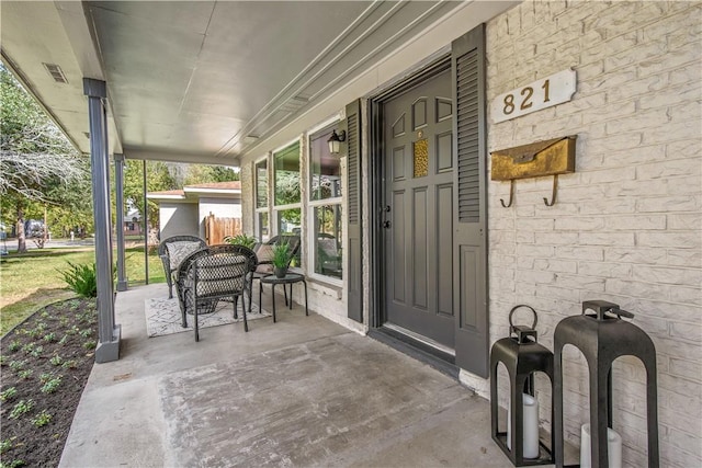 view of exterior entry featuring a porch