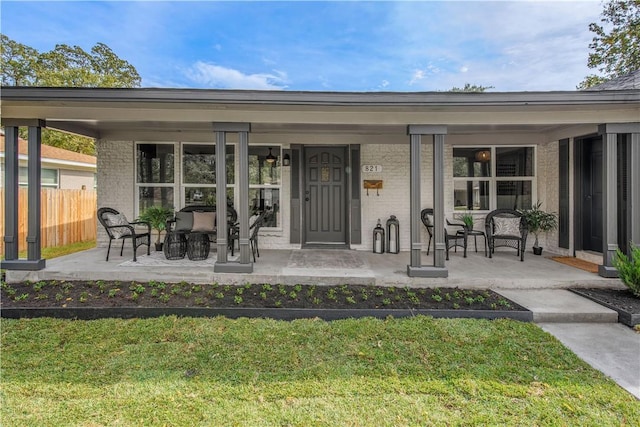 exterior space featuring a lawn and covered porch