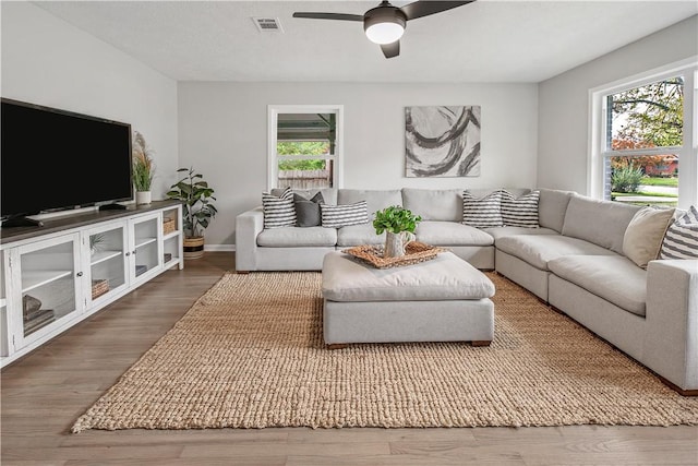 living room with hardwood / wood-style floors and ceiling fan