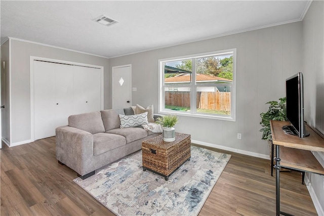 living room with dark hardwood / wood-style floors and ornamental molding