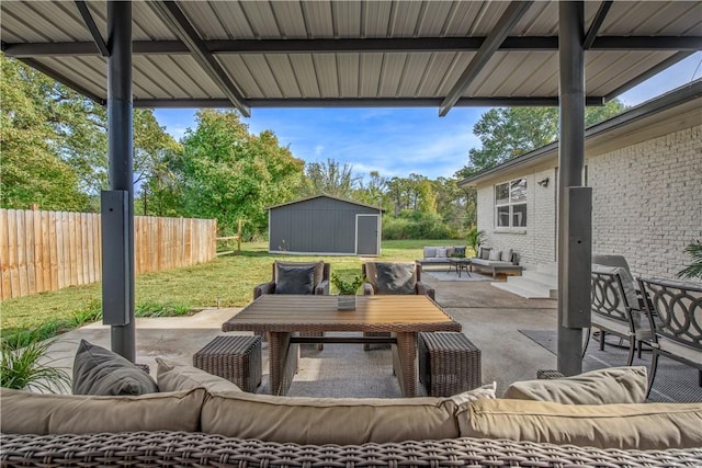 view of patio with outdoor lounge area and a storage unit