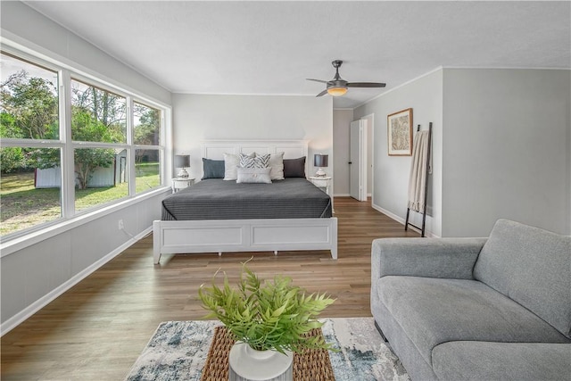 bedroom with ceiling fan and wood-type flooring