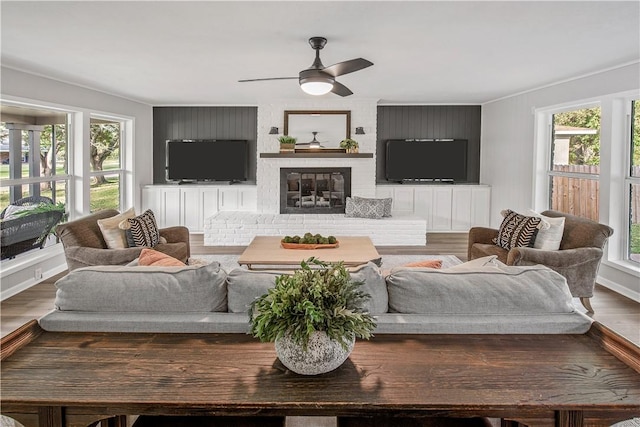 living room with hardwood / wood-style floors, a fireplace, and a wealth of natural light