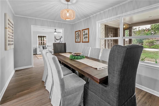 dining space with hardwood / wood-style flooring, crown molding, and a wealth of natural light