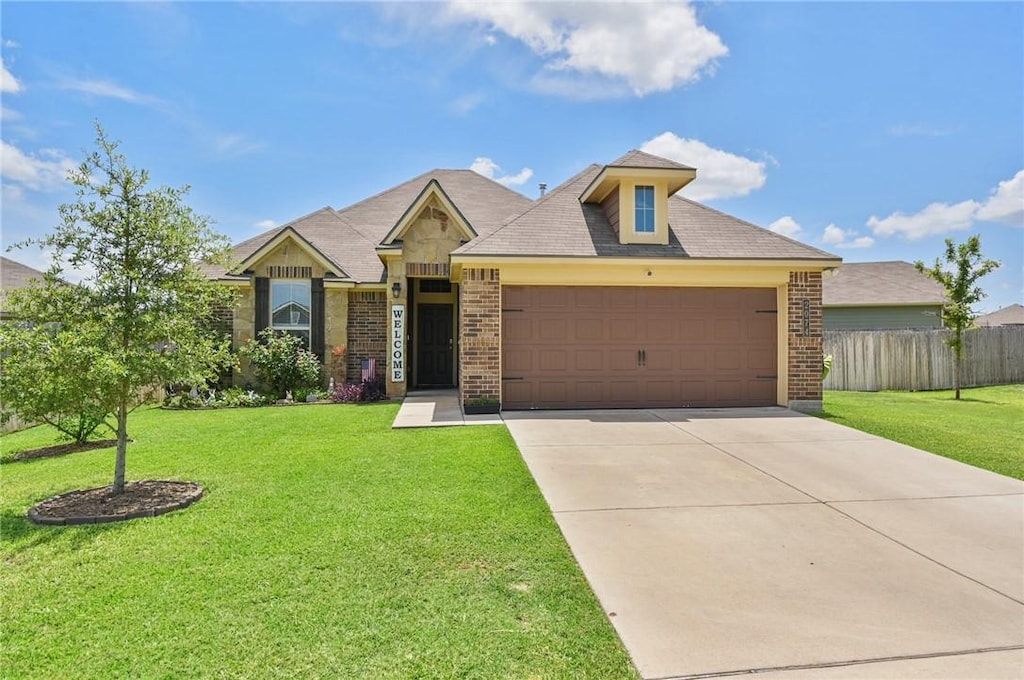 view of front of home with a front lawn and a garage