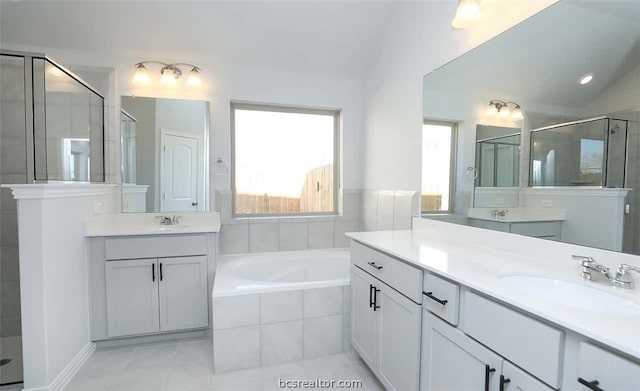 bathroom with tile patterned floors, vanity, lofted ceiling, and shower with separate bathtub