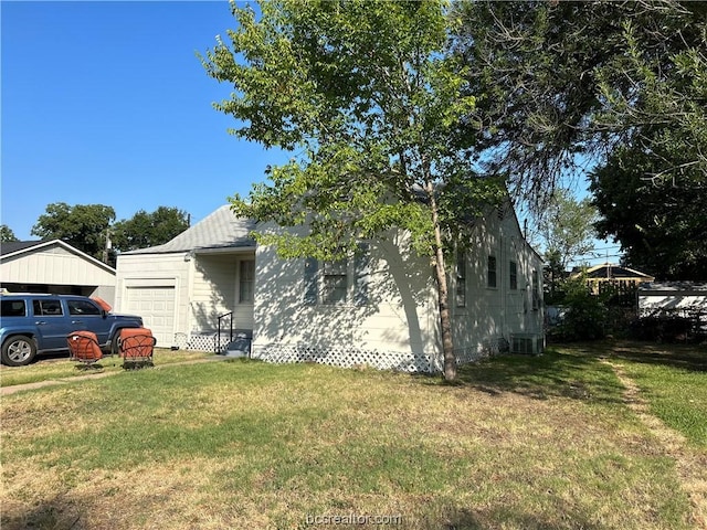 view of property exterior featuring central air condition unit and a yard